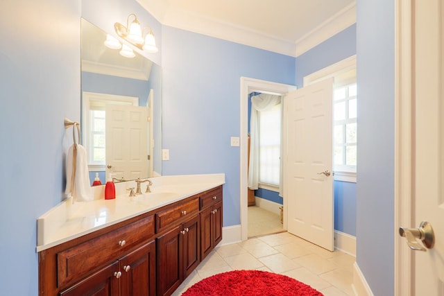 bathroom featuring baseboards, ornamental molding, tile patterned floors, and vanity