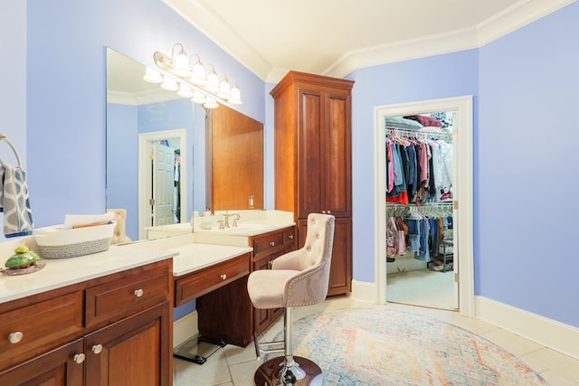 bathroom featuring vanity, ornamental molding, and a spacious closet
