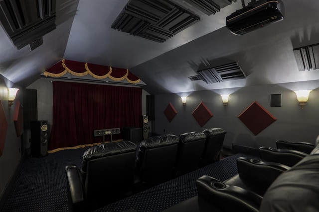 carpeted home theater featuring lofted ceiling