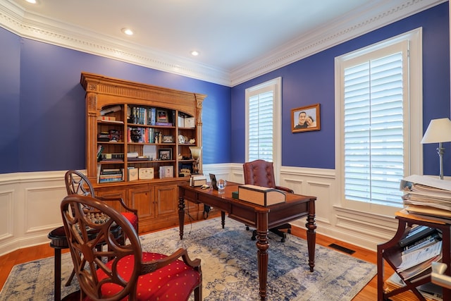 office area with ornamental molding, a wealth of natural light, and a wainscoted wall