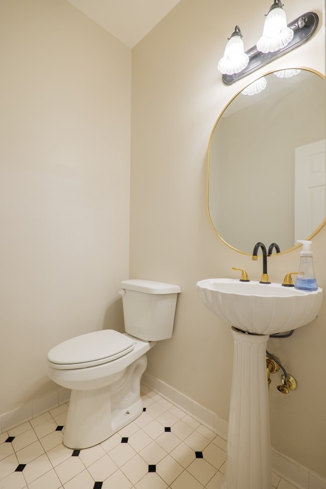 bathroom featuring baseboards, toilet, and tile patterned floors