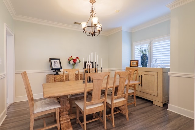 dining area with dark wood-style floors, crown molding, baseboards, and an inviting chandelier