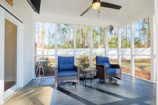 sunroom featuring ceiling fan