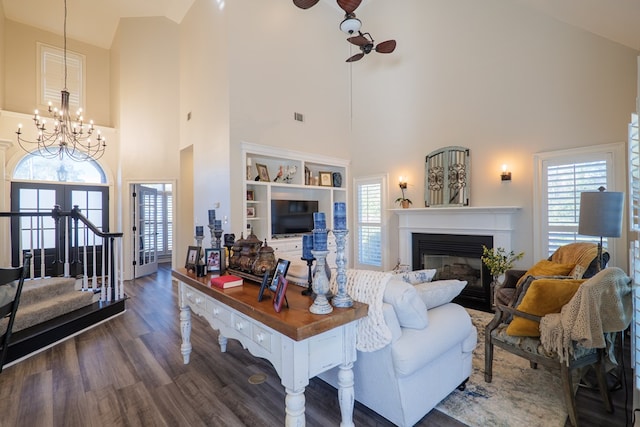 living room with dark wood-style floors, ceiling fan, a wealth of natural light, and a glass covered fireplace