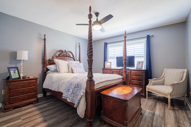 bedroom featuring dark wood-style floors, a textured ceiling, and a ceiling fan