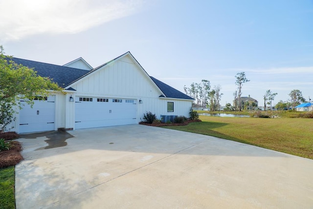 view of side of property with a lawn and a garage