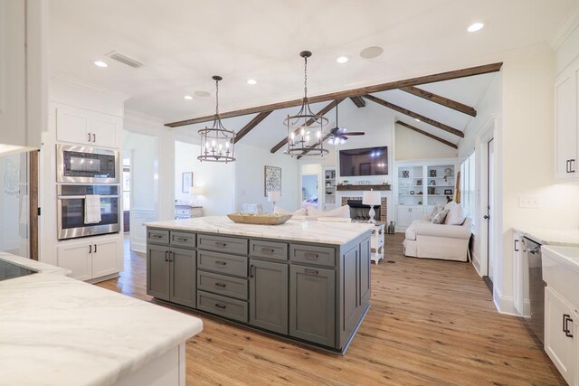 kitchen featuring gray cabinetry, white cabinetry, hanging light fixtures, stainless steel appliances, and vaulted ceiling with beams