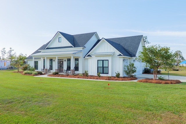 view of front facade with a front yard and a porch