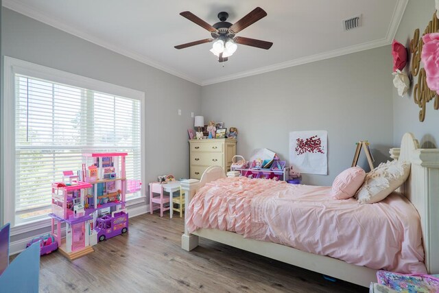 bedroom with multiple windows, ceiling fan, ornamental molding, and hardwood / wood-style flooring