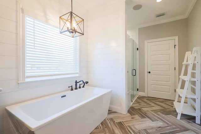 bathroom with shower with separate bathtub, an inviting chandelier, parquet floors, and ornamental molding