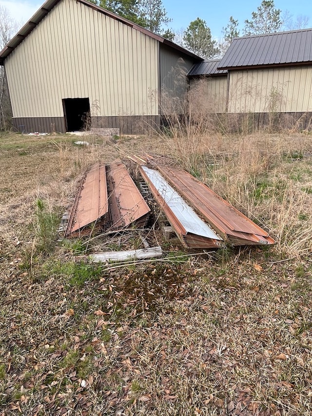exterior space featuring a pole building and metal roof