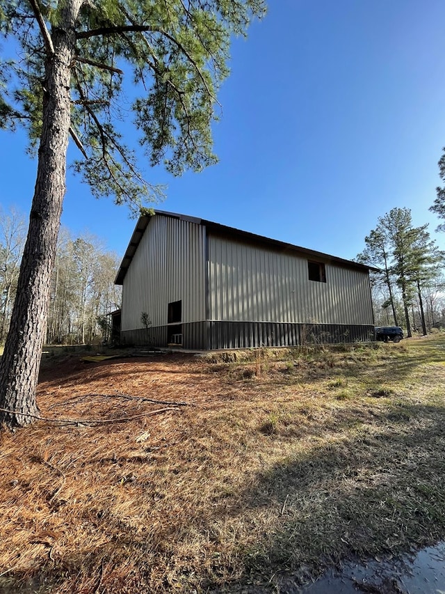 view of home's exterior featuring an outbuilding and an outdoor structure