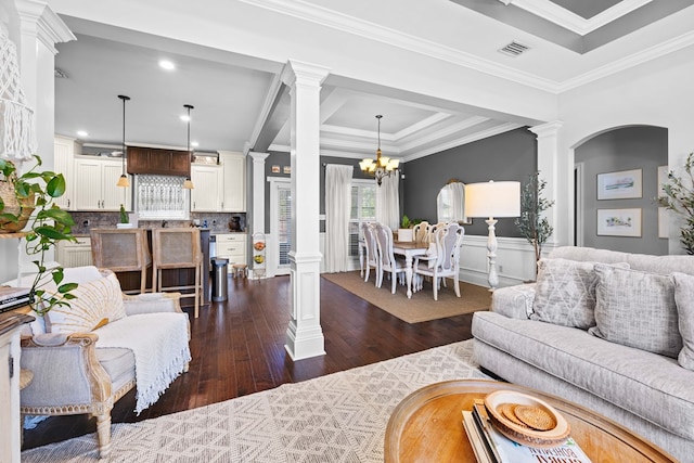 4186 Bowen Way, Valdosta, GA 31605 - living room featuring ornate columns, dark wood-style flooring, ornamental molding, a chandelier, and a wainscoted wall