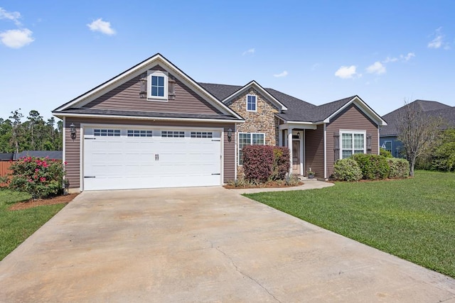 4186 Bowen Way, Valdosta, GA 31605 - view of front of house with a front yard, driveway, a garage, and stone siding