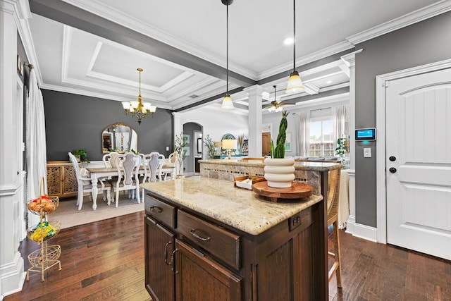 4186 Bowen Way, Valdosta, GA 31605 - kitchen with decorative columns, arched walkways, a kitchen bar, a ceiling fan, and dark wood-type flooring
