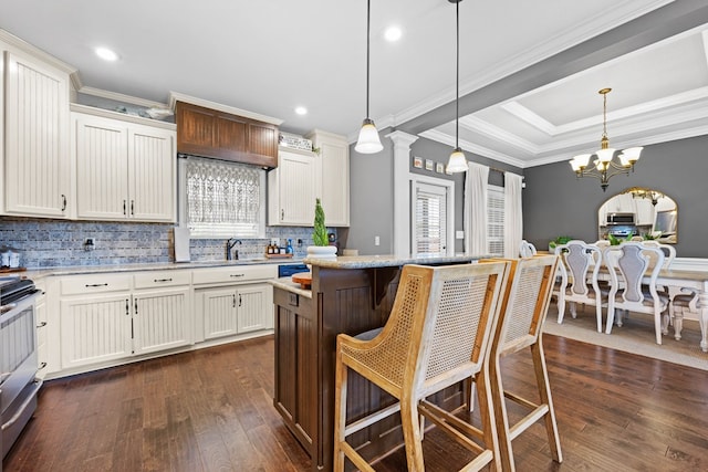 4186 Bowen Way, Valdosta, GA 31605 - kitchen featuring backsplash, appliances with stainless steel finishes, crown molding, dark wood finished floors, and a breakfast bar