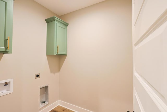 2830 Loch Laurel Rd, Valdosta, GA 31601 - laundry room featuring cabinet space, electric dryer hookup, hookup for a washing machine, baseboards, and light wood finished floors