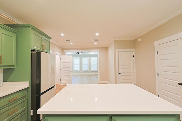 2830 Loch Laurel Rd, Valdosta, GA 31601 - kitchen featuring green cabinets, freestanding refrigerator, ceiling fan, light countertops, and ornamental molding