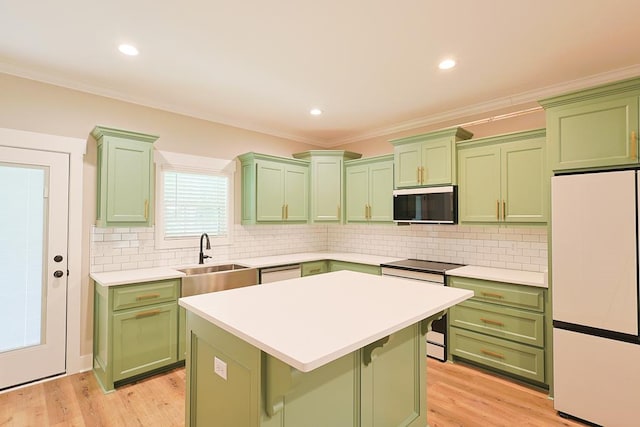 2830 Loch Laurel Rd, Valdosta, GA 31601 - kitchen featuring green cabinetry, appliances with stainless steel finishes, a sink, light countertops, and decorative backsplash