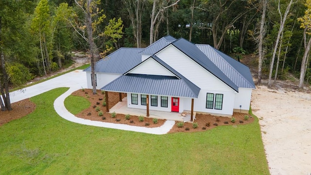2830 Loch Laurel Rd, Valdosta, GA 31601 - modern inspired farmhouse featuring driveway, metal roof, and a front yard