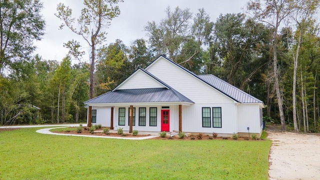 2830 Loch Laurel Rd, Valdosta, GA 31601 - modern inspired farmhouse featuring a front lawn, driveway, metal roof, and a porch