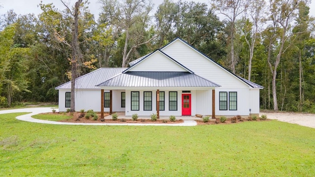 2830 Loch Laurel Rd, Valdosta, GA 31601 - modern farmhouse style home featuring a front lawn, metal roof, and covered porch