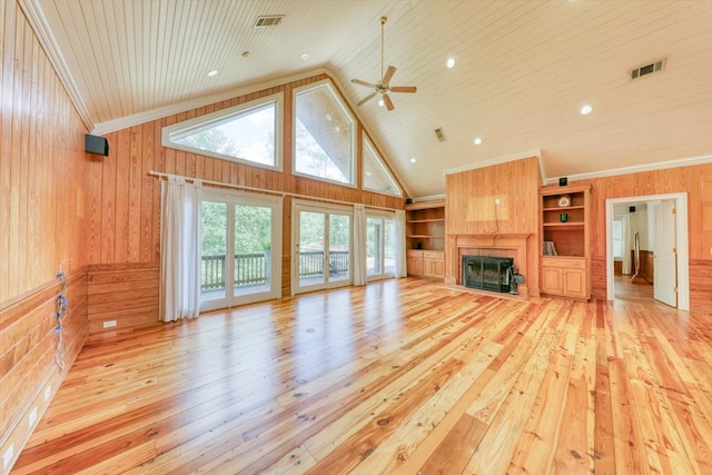 8262 Troupeville Rd, Valdosta, GA 31602 - unfurnished living room featuring wooden walls, light wood-style floors, wood ceiling, ceiling fan, and a fireplace