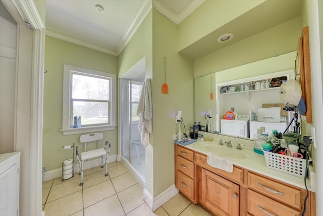 8262 Troupeville Rd, Valdosta, GA 31602 - full bath with crown molding, washer and dryer, vanity, tile patterned flooring, and a stall shower