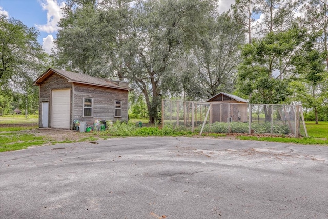 8262 Troupeville Rd, Valdosta, GA 31602 - view of yard featuring an outdoor structure and a garage