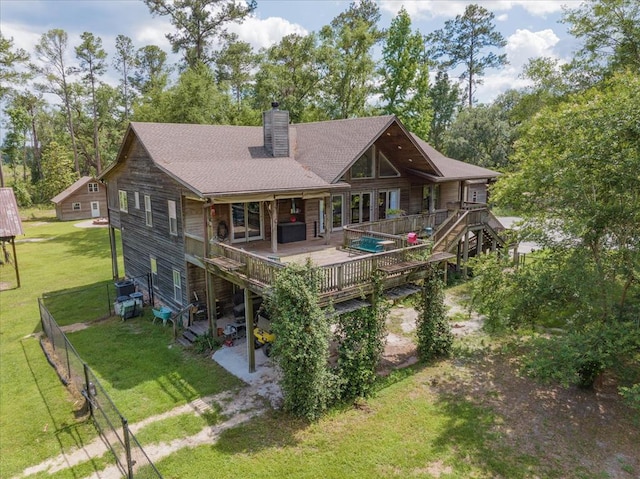 8262 Troupeville Rd, Valdosta, GA 31602 - rear view of property featuring a chimney, a wooden deck, and view of scattered trees