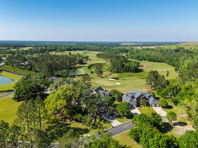 birds eye view of property featuring view of golf course and a water view