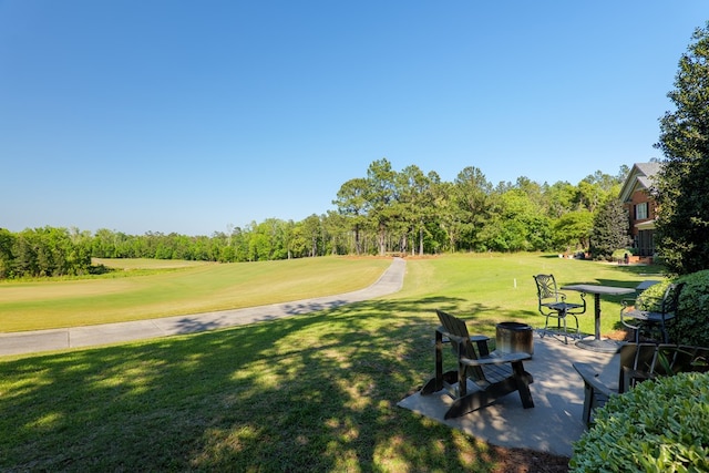 view of property's community with a yard and golf course view