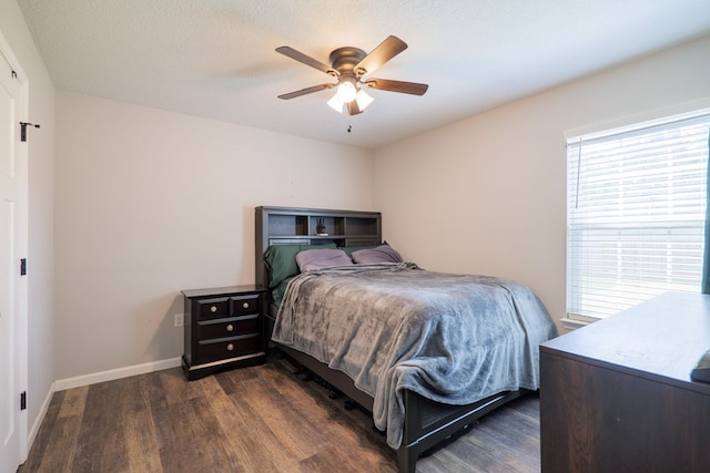 bedroom featuring ceiling fan, dark hardwood / wood-style floors, and a textured ceiling