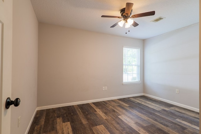 empty room featuring a textured ceiling, dark hardwood / wood-style floors, and ceiling fan