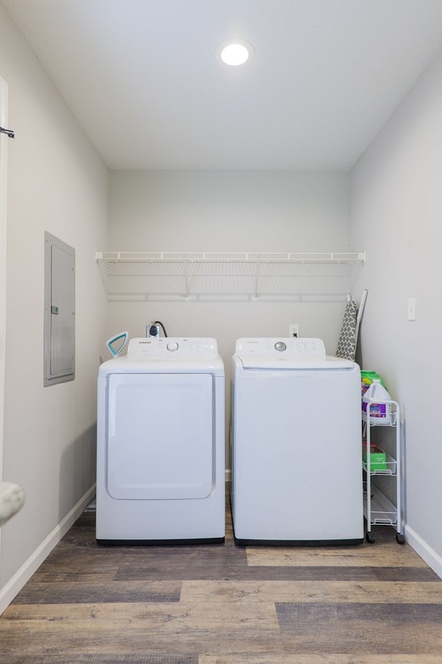 washroom featuring independent washer and dryer, dark wood-type flooring, and electric panel