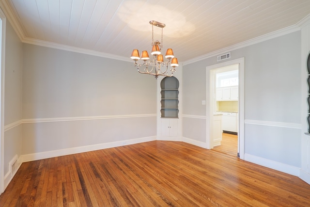 spare room with ornamental molding, hardwood / wood-style flooring, visible vents, and baseboards