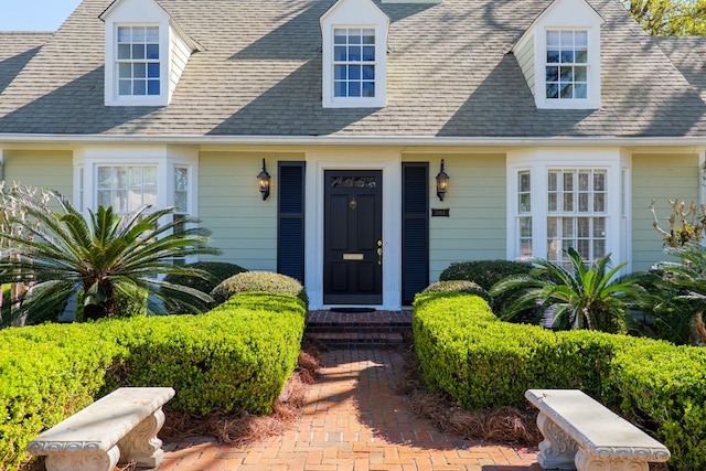 entrance to property with roof with shingles