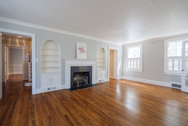 unfurnished living room with built in shelves, visible vents, a fireplace, and wood finished floors