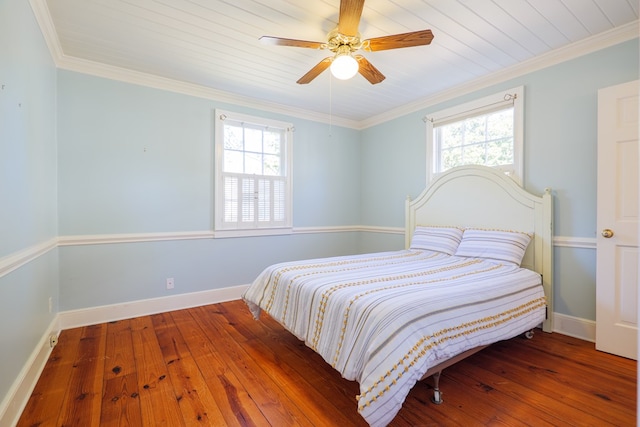 bedroom featuring hardwood / wood-style flooring, ceiling fan, baseboards, and crown molding