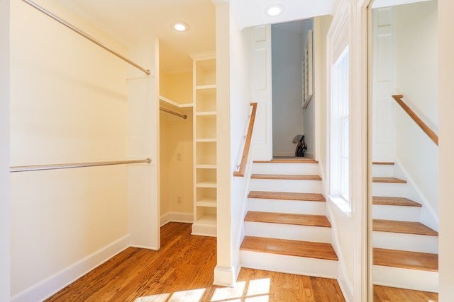 stairs featuring recessed lighting, baseboards, and wood finished floors