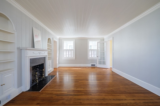 unfurnished living room with built in features, visible vents, ornamental molding, a high end fireplace, and wood finished floors