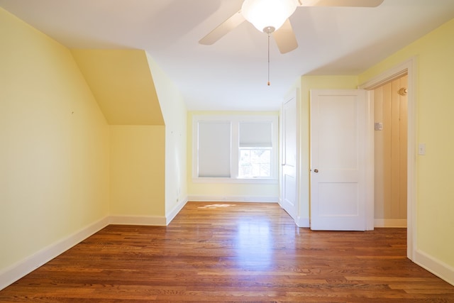 additional living space with lofted ceiling, wood finished floors, a ceiling fan, and baseboards