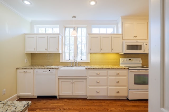kitchen featuring ornamental molding, white appliances, plenty of natural light, and a sink