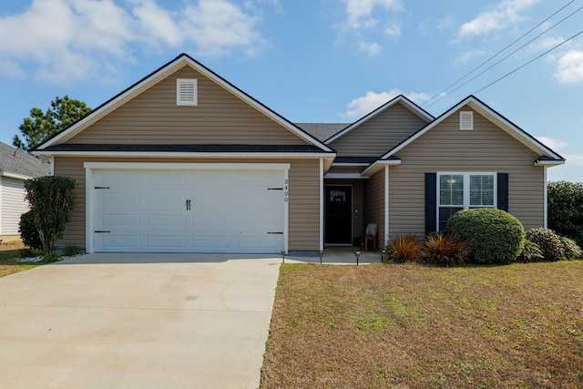 view of front of home featuring a garage and a front lawn