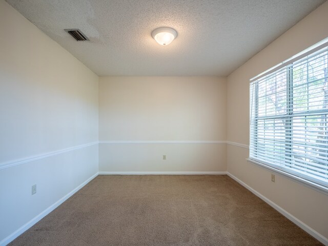 5210 N Northridge Rd, Valdosta, GA 31605 - carpeted empty room with a textured ceiling, baseboards, and visible vents
