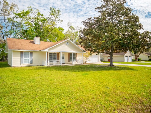5210 N Northridge Rd, Valdosta, GA 31605 - single story home with covered porch, a chimney, a front lawn, and an attached garage