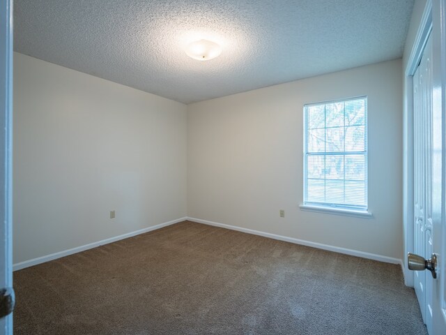 5210 N Northridge Rd, Valdosta, GA 31605 - spare room with baseboards, a textured ceiling, and carpet
