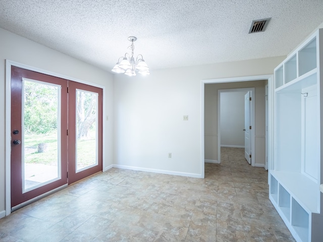 5210 N Northridge Rd, Valdosta, GA 31605 - spare room featuring baseboards, a notable chandelier, visible vents, and a textured ceiling