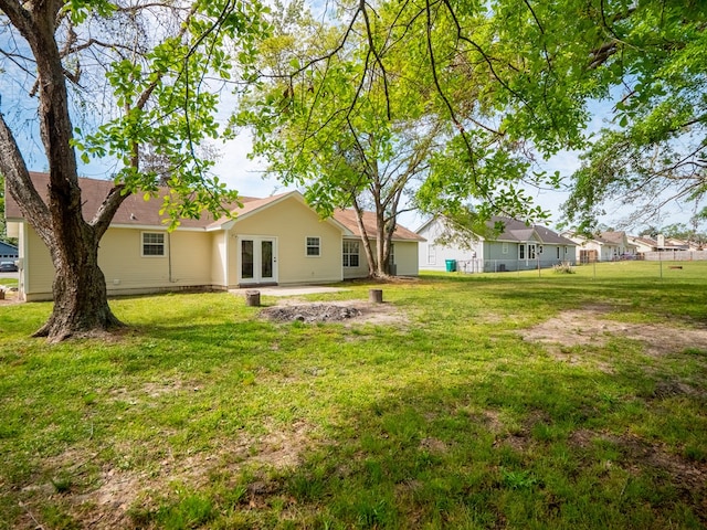 5210 N Northridge Rd, Valdosta, GA 31605 - back of property featuring a lawn, fence, and french doors