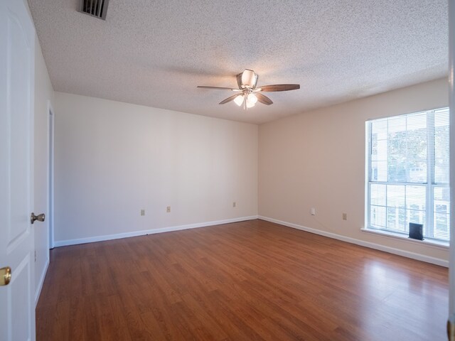 5210 N Northridge Rd, Valdosta, GA 31605 - spare room featuring baseboards, a textured ceiling, visible vents, ceiling fan, and wood finished floors